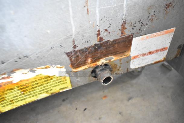 Vulcan 48RPG-E stainless steel commercial griddle underside showing visible rust and worn labels.