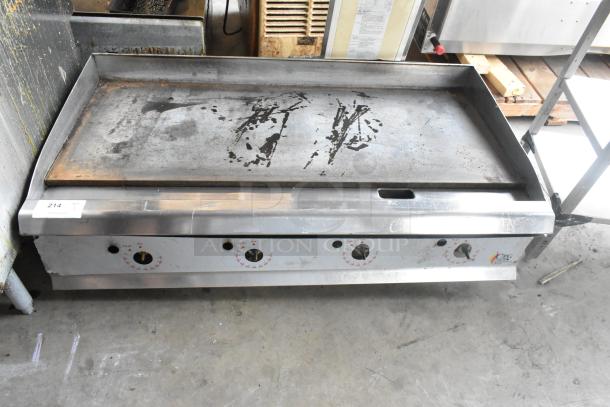 Cooking Performance Group stainless steel commercial countertop gas griddle, used, with visible control knobs and cooking surface wear.