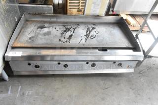 Cooking Performance Group stainless steel commercial countertop gas griddle, used, with visible control knobs and cooking surface wear.
