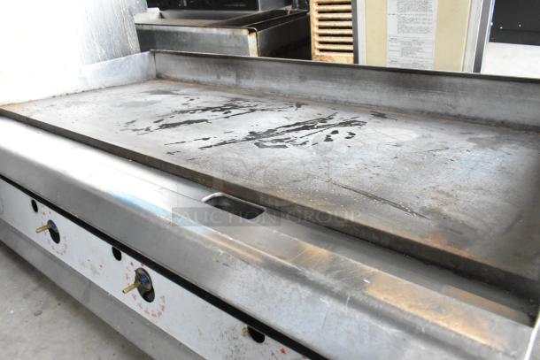 Cooking Performance Group stainless steel gas griddle, commercial countertop model, worn surface, functional condition.