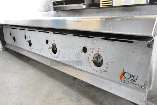 Cooking Performance Group CPG stainless steel commercial countertop gas griddle with multiple controls, showing signs of use.