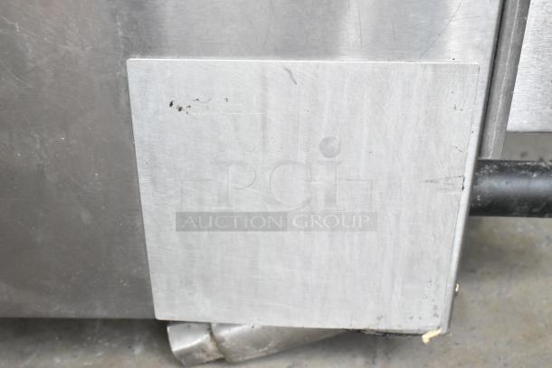 Stainless steel surface of a Cooking Performance Group CPG commercial gas griddle, showing minor wear and scratches.