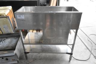 Stainless steel commercial refrigerated cold pan, used condition, mounted on a sturdy frame, tag shows item number 215.