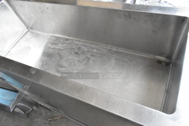 Stainless steel commercial refrigerated cold pan, large capacity, slightly worn surface, no visible markings or labels.