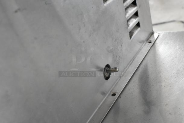 Stainless steel commercial refrigerated cold pan, vent detail, shows moderate wear, switch visible.