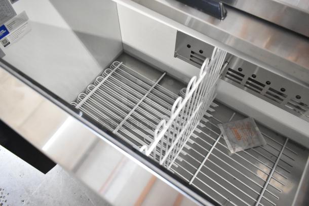 Brand new 2024 Avantco 178HBB95HC commercial metal bottle cooler, 95" black horizontal, 115V, 1 Phase, interior view.
