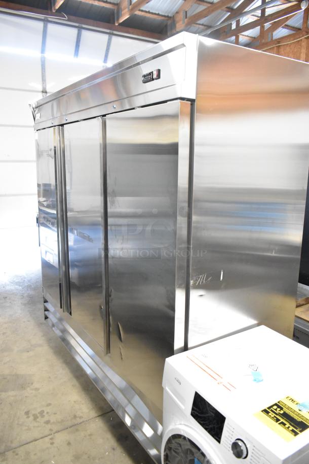 Brand new Avantco 178SS3FHC 3-door stainless steel reach-in cooler, scratch and dent, with poly-coated racks, on casters.