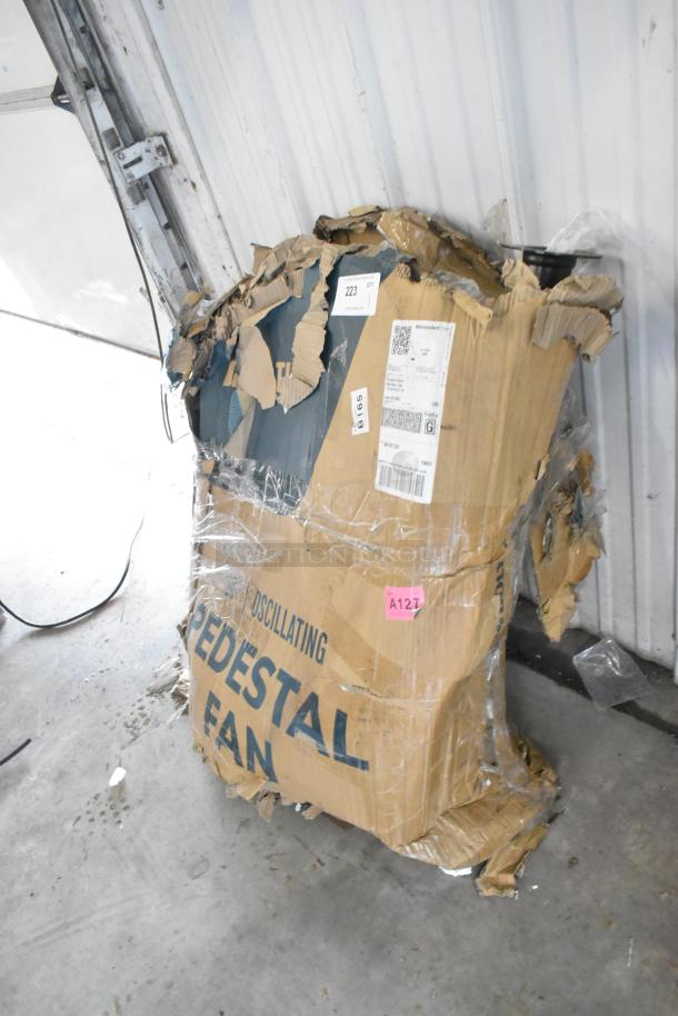 Damaged box of a brand new Boltic 30" Oscillating Pedestal Fan with visible scratches and dents. Shipping labels intact.