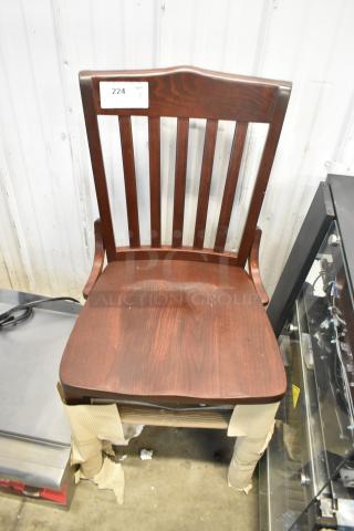 Brand new wooden dining height chair, scratch and dent. Dark finish, slatted back, sturdy construction, auction tag visible.