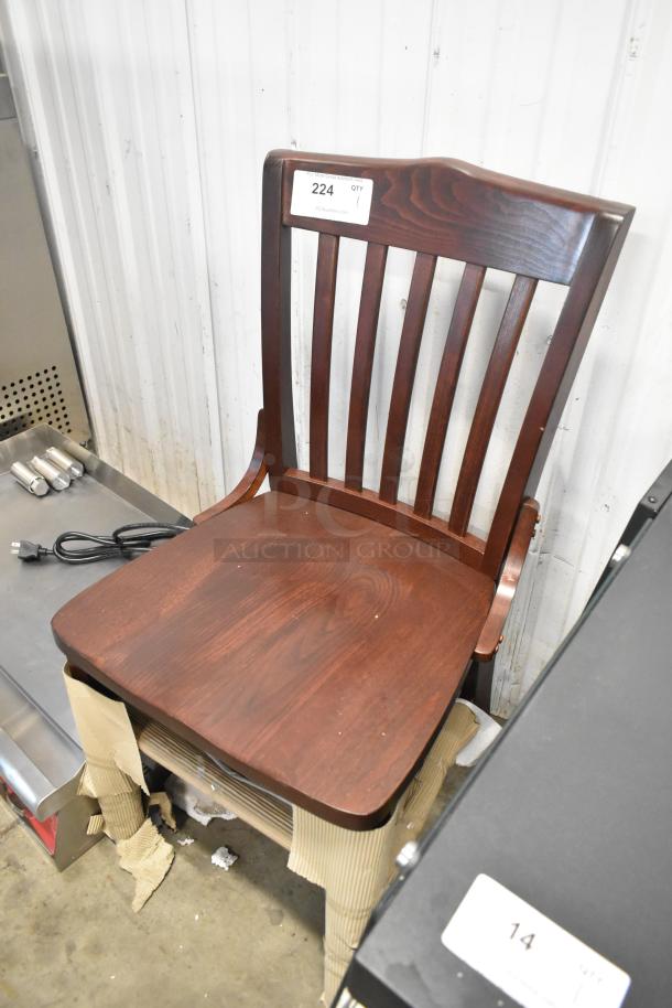 Brand new wooden dining chair with scratches and dents, dark wood finish, slatted back, auction tag "224".