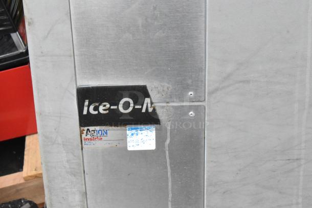 Ice O Matic metal commercial ice machine, 115 volts, 1 phase. Silver exterior with visible branding and inspection stickers.