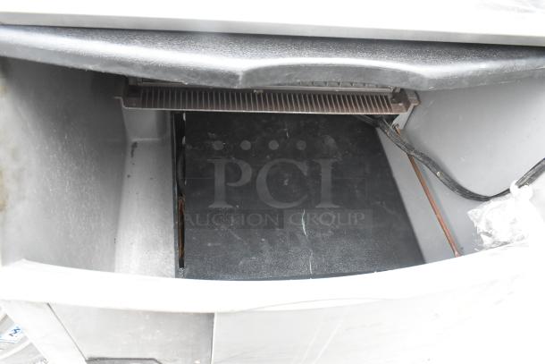 Ice O Matic metal commercial ice machine, self-contained, 115 volts, 1 phase, interior view, used condition.