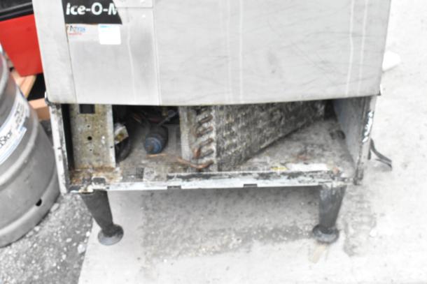 Ice O Matic metal commercial ice machine, self-contained, 115 volts, 1 phase. Visible wear and internal components.
