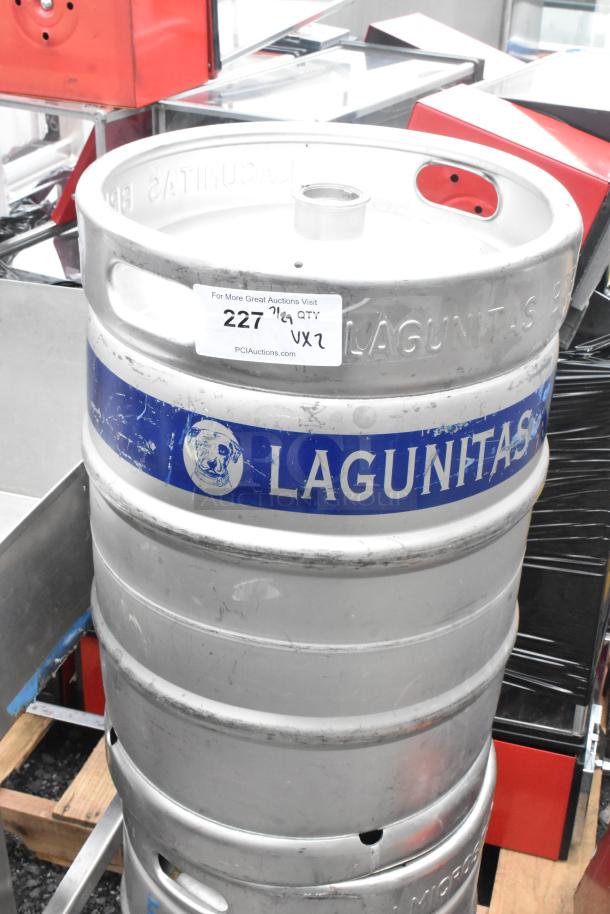 Two Lagunitas metal half barrel kegs with branding and auction label. Good condition, durable stainless steel.