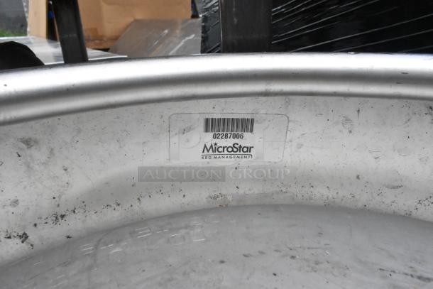 Two metal half-barrel kegs by MicroStar with visible barcode label, in used condition.