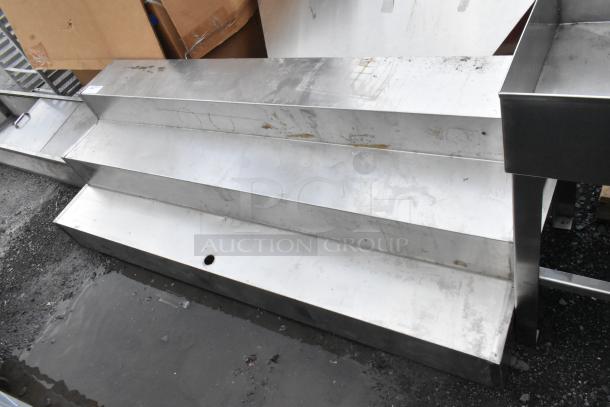Metal 3-tier display in used condition, showcasing some surface wear. Ideal for retail or exhibition use.