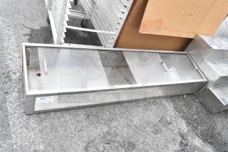 Metal cabinet with clear doors, two handles, laid horizontally, silver finish. Visible label: "230". Good condition.
