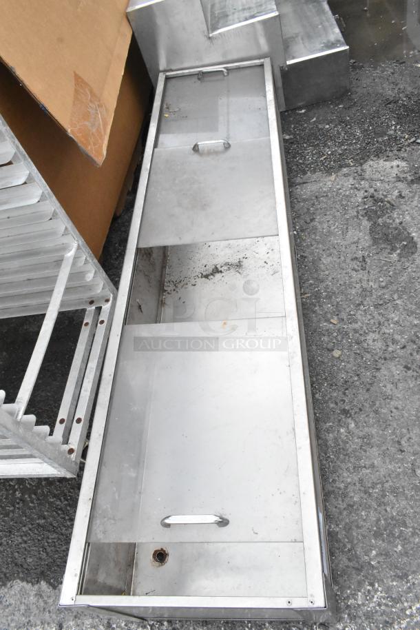 Metal cabinet with clear doors, handles visible; shows signs of wear, located outdoors, likely used for storage.