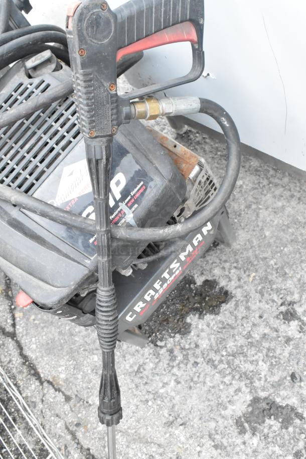 Craftsman 580.762250 pressure washer, used, sturdy metal and plastic construction, visible hose and spray wand.