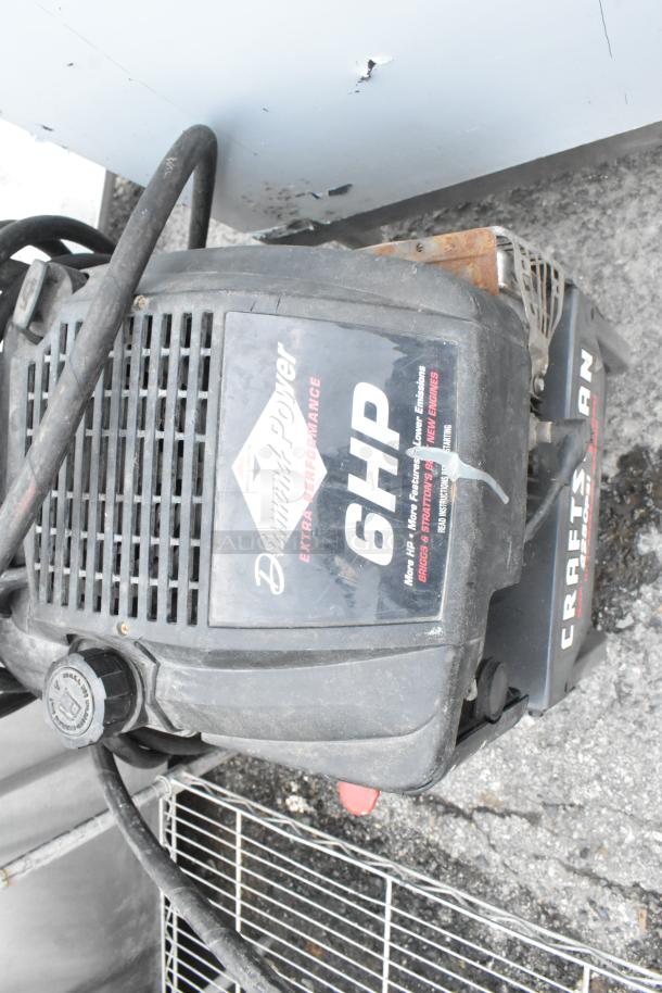 Craftsman 580.762250 pressure washer, 6HP engine, visible wear, black casing, Craftsman label, ideal for cleaning tasks.