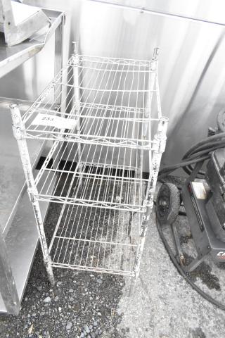 Chrome finish 3-tier wire shelving unit, visible wear. Buyer must dismantle for shipping. Consider freight costs.