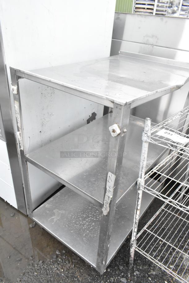 Metal 3-tier cart with commercial casters, showing surface wear. Comes with labels indicating industrial use.