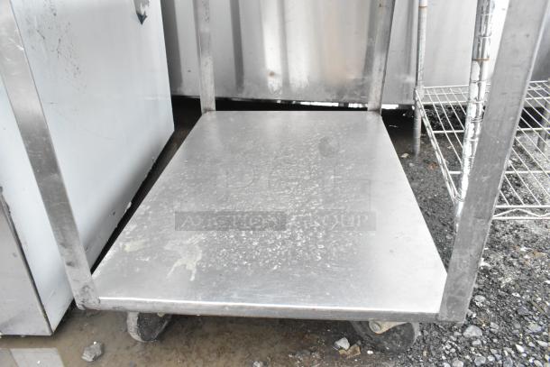 Metal 3 tier cart on commercial casters, showing a sturdy metal shelf with visible wear, ideal for heavy-duty use.