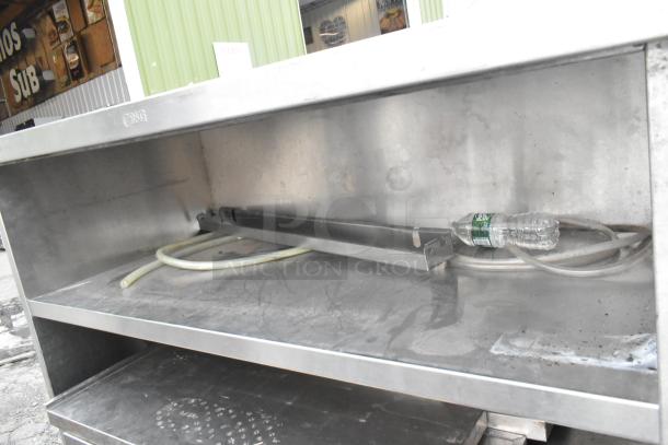 Stainless steel commercial table with 2 under shelves and commercial casters, used condition, minor surface marks.