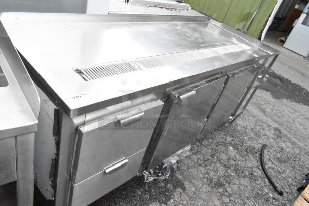 Stainless steel commercial undercounter cooler with 2 doors and 2 drawers, in good condition, featuring a vented top.