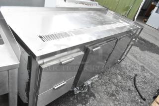 Stainless steel commercial undercounter cooler with 2 doors and 2 drawers, in good condition, featuring a vented top.