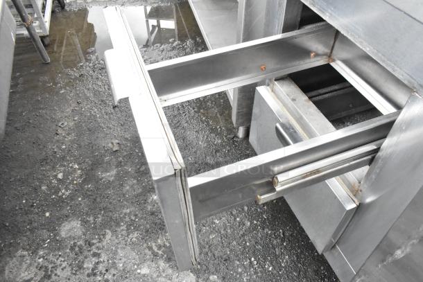 Stainless steel undercounter cooler with open drawer, showing sleek construction and sturdy metal handles.
