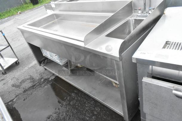 Atlas Metal stainless steel commercial ice bin with right side single sink bay, featuring dual faucets and lower storage.