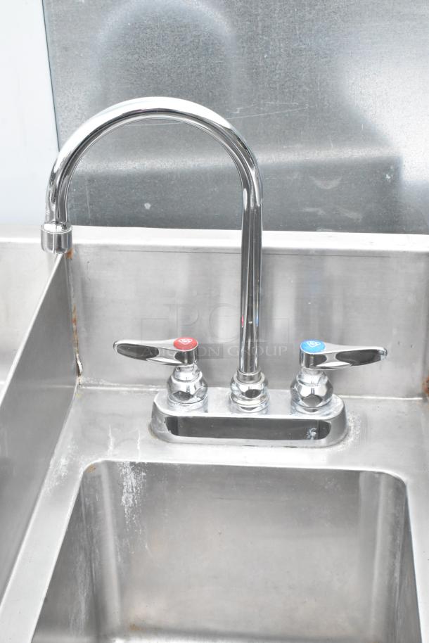 Atlas Metal stainless steel ice bin with right side single sink bay and dual faucet, showing minor wear.