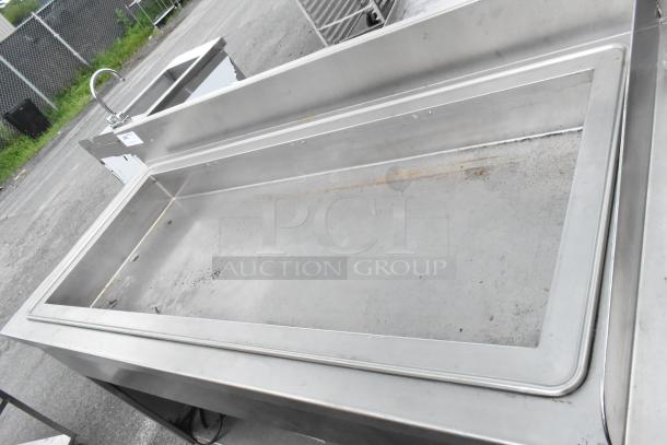 Atlas Metal stainless steel commercial ice bin with right side single sink bay, featuring a faucet. Slight surface wear visible.