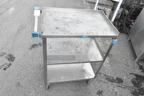 Lakeside metal 3-tier cart on commercial casters, showing signs of wear, sturdy design, handle attached, labeled for commercial use.