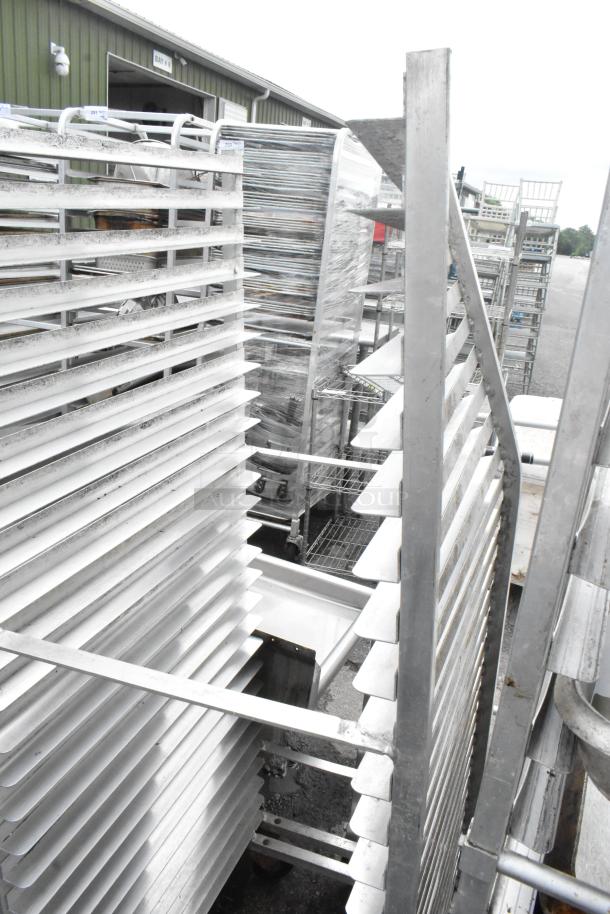 Metal commercial pan transport rack with multiple shelves and commercial casters. Suitable for kitchen use.