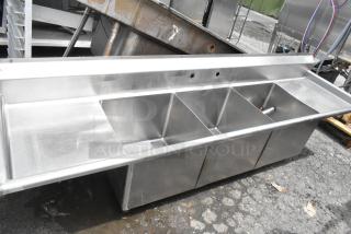 Stainless steel 3 bay sink with dual drain boards, featuring durable construction and multiple compartments, ideal for commercial use.