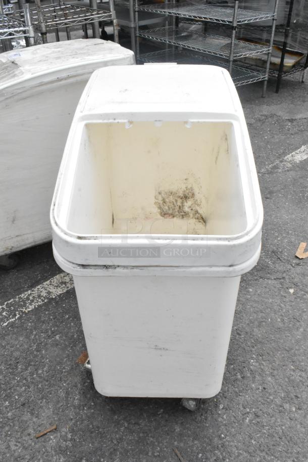 White poly ingredient bin with commercial casters, used condition, visible wear inside.