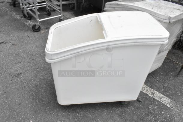 White poly ingredient bin on commercial casters, used condition, durable construction, ideal for storage, easy mobility.