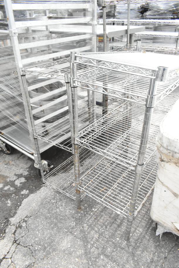 Two chrome finish 3-tier wire shelving units, each measuring 24x14x34 inches, in good condition.