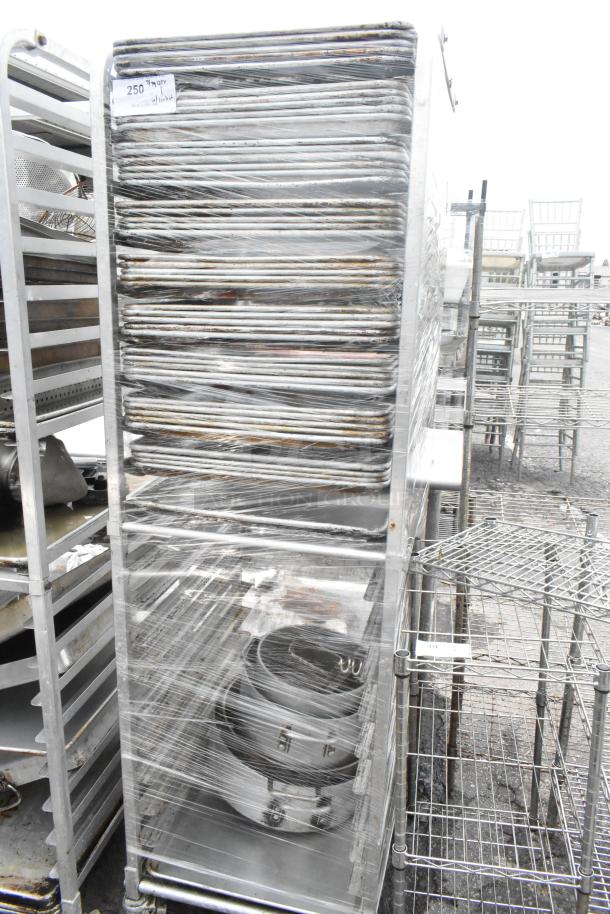 Metal pan transport rack with 46 full-size baking pans, on commercial casters. Wrapped, used condition.