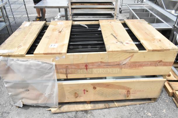 Brand new crate containing ten 23-1/8"x60" glass doors. Crate marked "GLASS-HANDLE WITH CARE" for protection.