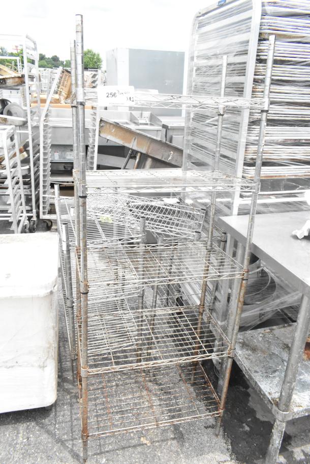 Chrome finish 5 tier wire shelving unit, rusted condition, buyer must dismantle, freight charges apply.