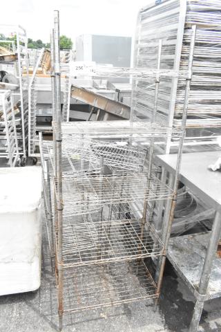 Chrome finish 5 tier wire shelving unit, rusted condition, buyer must dismantle, freight charges apply.