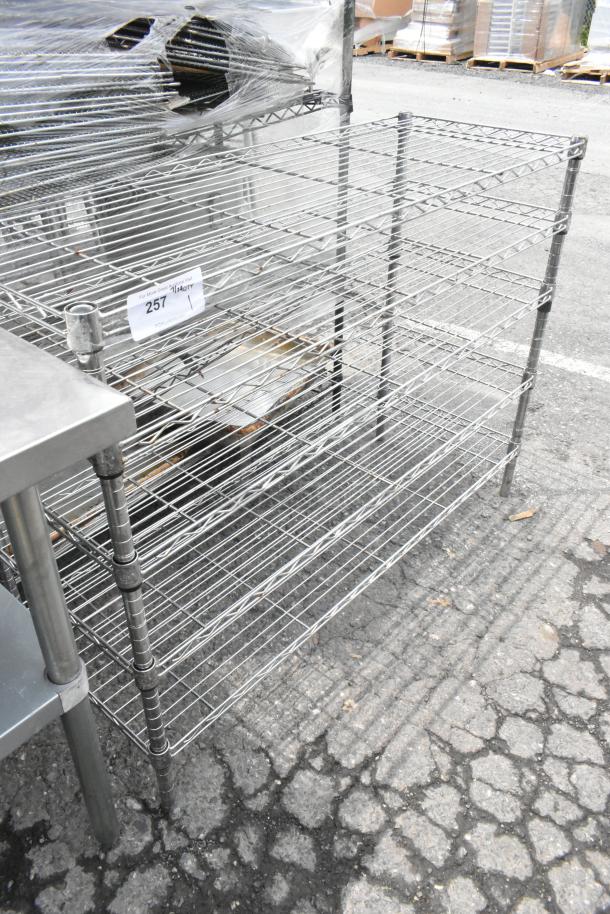 Chrome finish wire shelving unit, 5 tiers, sturdy build. Buyer must dismantle for shipping. Auction tag number 257 visible.