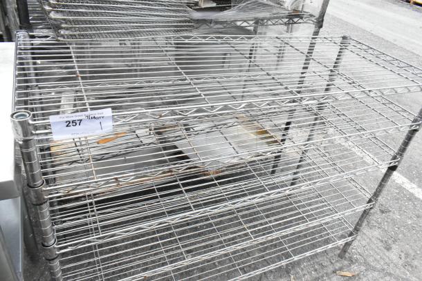 Chrome finish 5 tier wire shelving unit in good condition. Note: Buyer must dismantle for shipping. Marked "257."