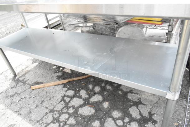 Stainless steel table with metal under shelf, visibly sturdy. The surface shows minor scratches, indicating prior use.