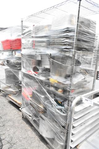 Chrome 4-tier wire shelving unit with colanders, bins, and stock pots wrapped for auction. Buyer must dismantle. Consider freight.