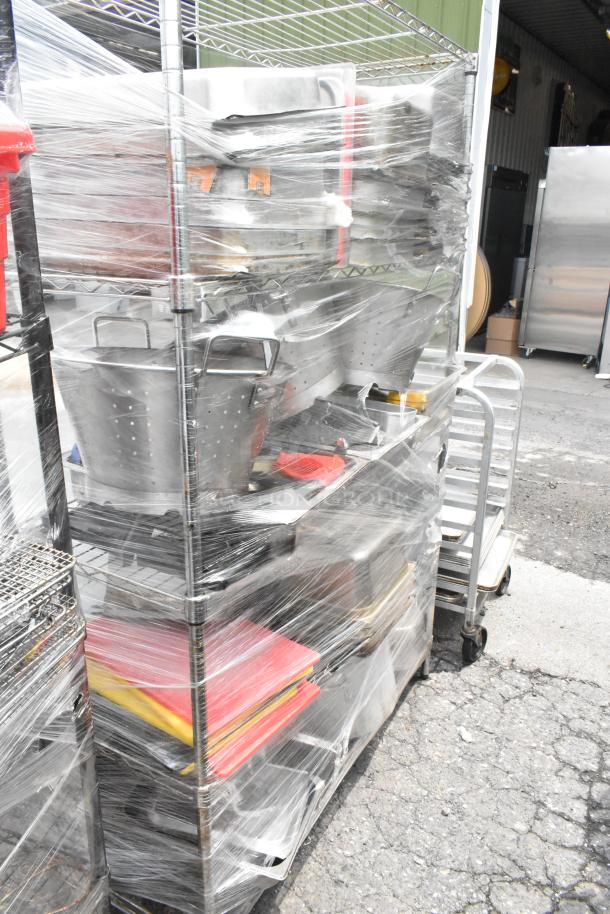 Chrome finish 4-tier wire shelving unit with colanders, drop-in bins, and stock pots, wrapped in plastic. Buyer to dismantle.