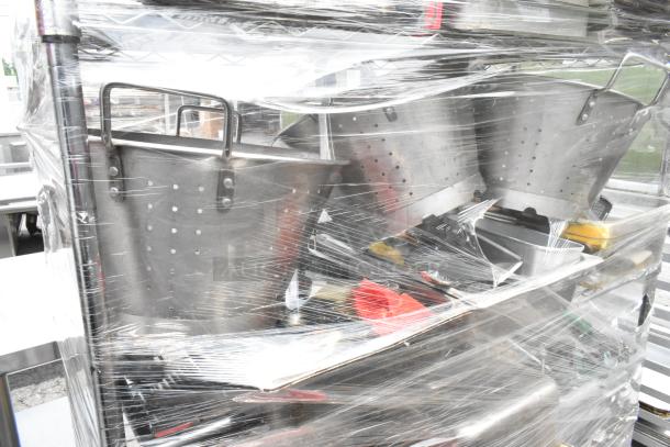 Chrome finish 4-tier wire shelving unit with colanders, bins, and stock pots, shrink-wrapped. Buyer must dismantle.
